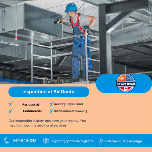 Inspection of air ducts performed by Power hvac services technician standing on scafold. Technician is in blue construction gem dress and inspecting duct with the help of a flash light.